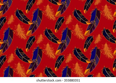 Vector seamless pattern with colored feathers dark blue and orange color on a red background. It can be used for fabric or wrapping paper.
