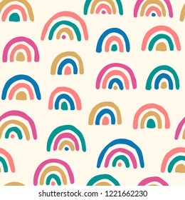 Vector seamless pattern with colored rainbows. Simple repeated texture with bright design elements. Tenmplate for baby textile and wrapping paper. Geometric background with hand drawn elements.