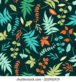 Vector seamless pattern with colorful leaves on a dark blue background.