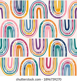 Vector seamless pattern with colorful rainbows. Bright repeated texture with brush strokes. Childish print for kids fabric and wrapping paper. Hand-drawn background.