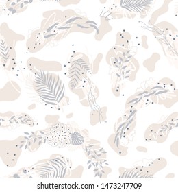 Vector seamless pattern of compositions from an abstract background brush and ink and silhouettes of various tropical leaves in pastel colors.