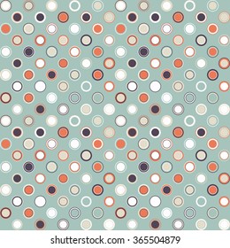 Vector seamless pattern. Consists of geometric elements arranged on celadon background.The elements have a circular shape and different color.