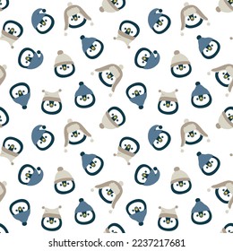 Vector seamless pattern with cute muzzles of penguins in hats