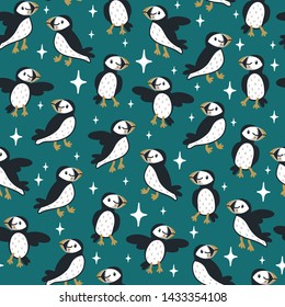Vector seamless pattern with cute puffins and sparkles. Repeated texture with icelandic birds. Childish print for kids fabric and wrapping paper with cartoon characters. Scandinavian style.