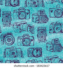 Vector seamless pattern with cute retro cameras with jeans texture.