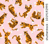 Vector seamless pattern with cute tigers on the pink background. Circus animal  show. Fashionable fabric design.