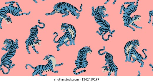 Vector seamless pattern with cute tigers on the pink background. Circus animal show. Fashionable fabric design.