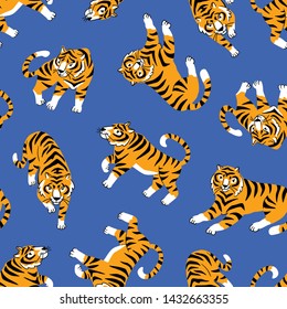 Vector seamless pattern with cute tigers on the blue background. Circus animal show. Fashionable fabric design.