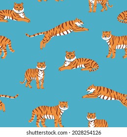 Vector seamless pattern with cute tigers on the blue background. Circus animal show. Tiger year. Fashionable fabric design.