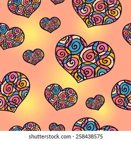 Vector seamless pattern with doodle multicolored hearts on warm bright summer background of pale yellow and orange color. Hearts are decorated with swirling spiral ornaments.