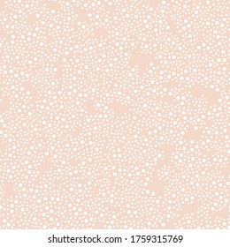 Vector seamless pattern with dots in peach color background