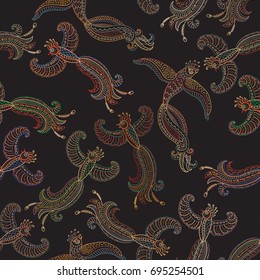 Vector seamless pattern in ethnic style.Exotic flying birds, colorful contour thin line drawing with folk ornaments on a black background.Embroidery silhouette,wallpaper, textile print, wrapping paper