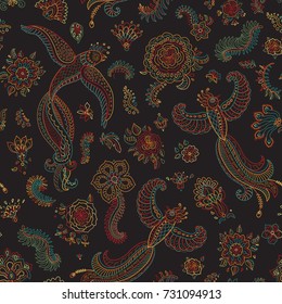 Vector seamless pattern in ethnic style.Exotic flying birds, colorful contour thin line fantasy flowers with folk ornaments on a black background. Embroidery, wallpaper, textile print, wrapping paper