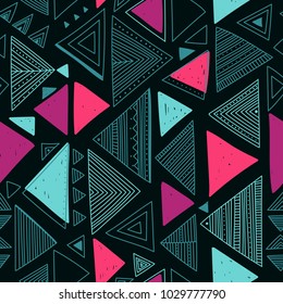 Vector seamless pattern with ethnic tribal boho trendy doodle triangle ornaments. Can be printed and used as wrapping paper, wallpaper, textile, fabric, etc.