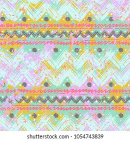 Vector seamless pattern with ethnic and tribal motifs in romantic bright colors. Bold bohemian texture with hand drawn chevrons, brushed lines, watercolor splatters and dots. Print in boho chic style