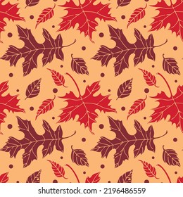 vector seamless pattern with fall leaves on the orange background