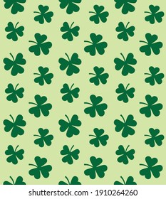 Vector seamless pattern of flat clover shamrock isolated on green background