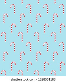 Vector seamless pattern of flat colored Christmas candy isolated on blue background