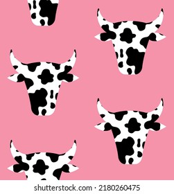 Vector seamless pattern of flat cow head with cow print isolated on pink background