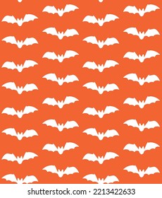 Vector seamless pattern of flying bat silhouette isolated on orange background