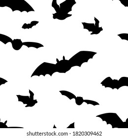 Vector seamless pattern with flying bats silhouettes. Halloween design on white background.
