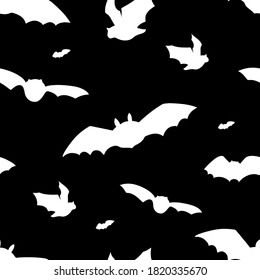 Vector seamless pattern with flying bats silhouettes. Halloween design on black background.