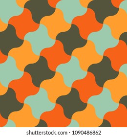 Vector seamless pattern in the form of a large number of a shuriken star mixed by vintage colors - orange, green, blue, yellow. Retro style.
