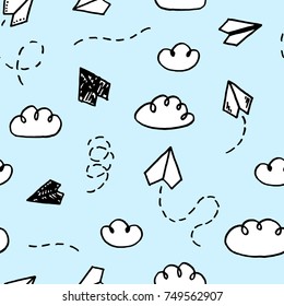 Vector seamless pattern with freehand drawn cartoon paper planes on blue background
