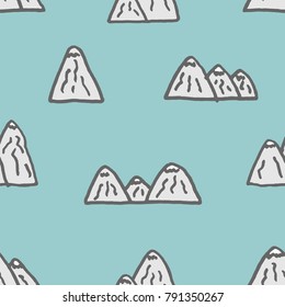Vector seamless pattern with freehand drawn cartoon mountains rocks made in kid childish style on cyan background