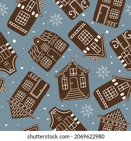 Vector seamless pattern with gingerbread houses with white sugar glaze on them and snowflakes at the background