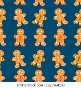 Vector seamless pattern with gingerbread men on blue background