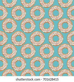 Vector seamless pattern with glazed white chocolate donuts on blue background