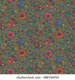 Vector seamless pattern with graphic doodle suns, stars and tribal elements. Hand drawn endless colorful background with many details and elements. Modern fashion textile design