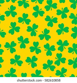 Vector seamless pattern. Green clover on a yellow background. National holiday St.Patrick 's Day.