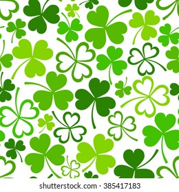 Vector seamless pattern with green shamrock leaves on a white background.