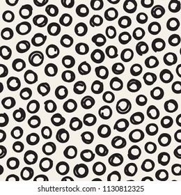 Vector seamless pattern with hand drawn nervous drawing. Sloppy background with doodles. Modern graphic design with small hand drawn rings. Randomly disposed rings.