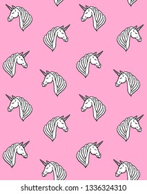 Vector seamless pattern of hand drawn doodle sketch white unicorn head isolated on pink background 