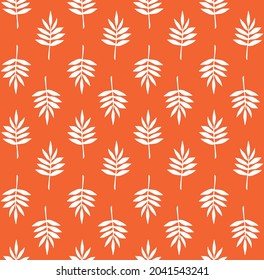 Vector seamless pattern of hand drawn doodle sketch leaf silhouette isolated on orange background