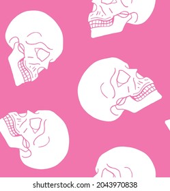 Vector seamless pattern of hand drawn doodle sketch human skull isolated on pink background