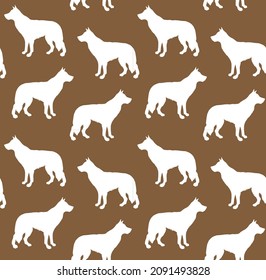 Vector seamless pattern of hand drawn shepherd dog silhouette isolated on brown background