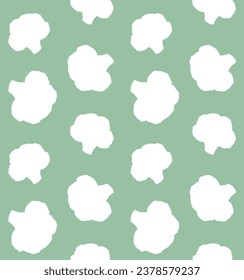 Vector seamless pattern of hand drawn broccoli silhouette isolated on green background