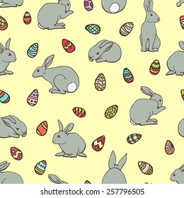 Vector seamless pattern with hand drawn cute bunnies and decorated Easter eggs.