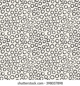 Vector seamless pattern with hand drawn nervous drawing. Sloppy background with doodles. Modern graphic design with small hand drawn rings. Randomly disposed rings.