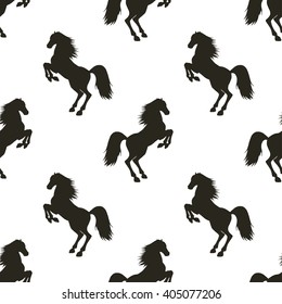 Vector seamless pattern with hand drawn silhouettes rearing horse.  In black and white colors.
