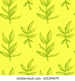 Vector seamless pattern with hand drawn green leaves on rich yellow background. Beautiful floral illustration made with chalk on textured paper.