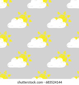 Vector seamless pattern with hand drawn yellow suns and white clouds on a gray background