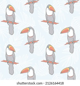 Vector seamless pattern with hand-drawn colorful toucans and palm leaves on a light blue background. Tropical print.