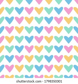 Vector seamless pattern with hearts on white background. Hearts for Valentine's Day rainbow colors. Perfect for textile, nursery and scrapbooking.
