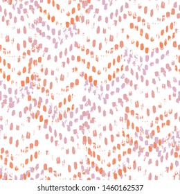 Vector seamless pattern of herringbone. Abstract background with brush strokes. Hand drawn texture with orange and pink color accents.
