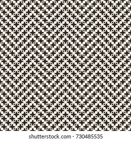 Vector seamless pattern. Infinitely repeating modern texture consisting of small crosses and dots which form zigzag geometrical shapes. Abstract seamless textured background.